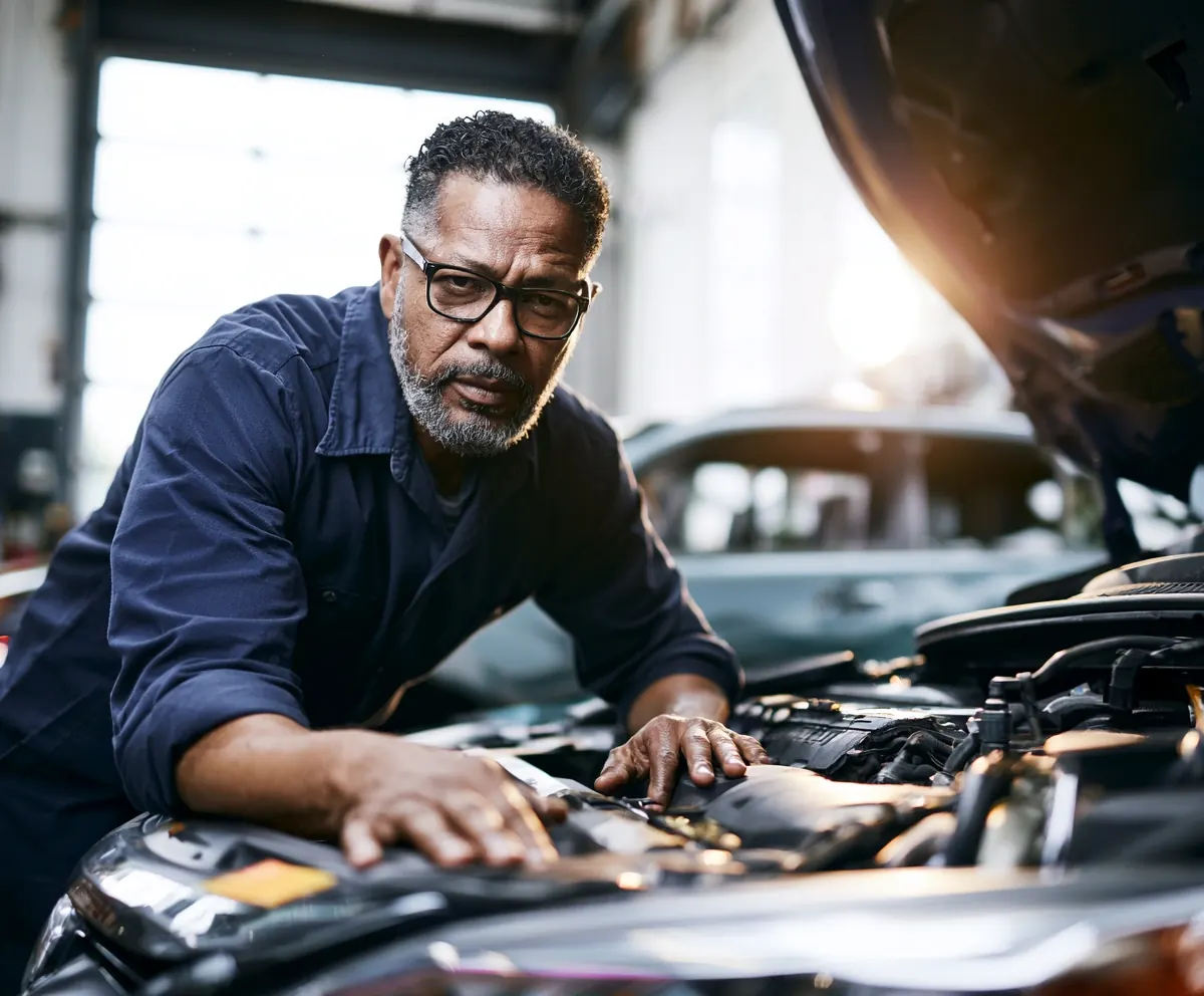 Mechanic repairing a car engine in a professional workshop