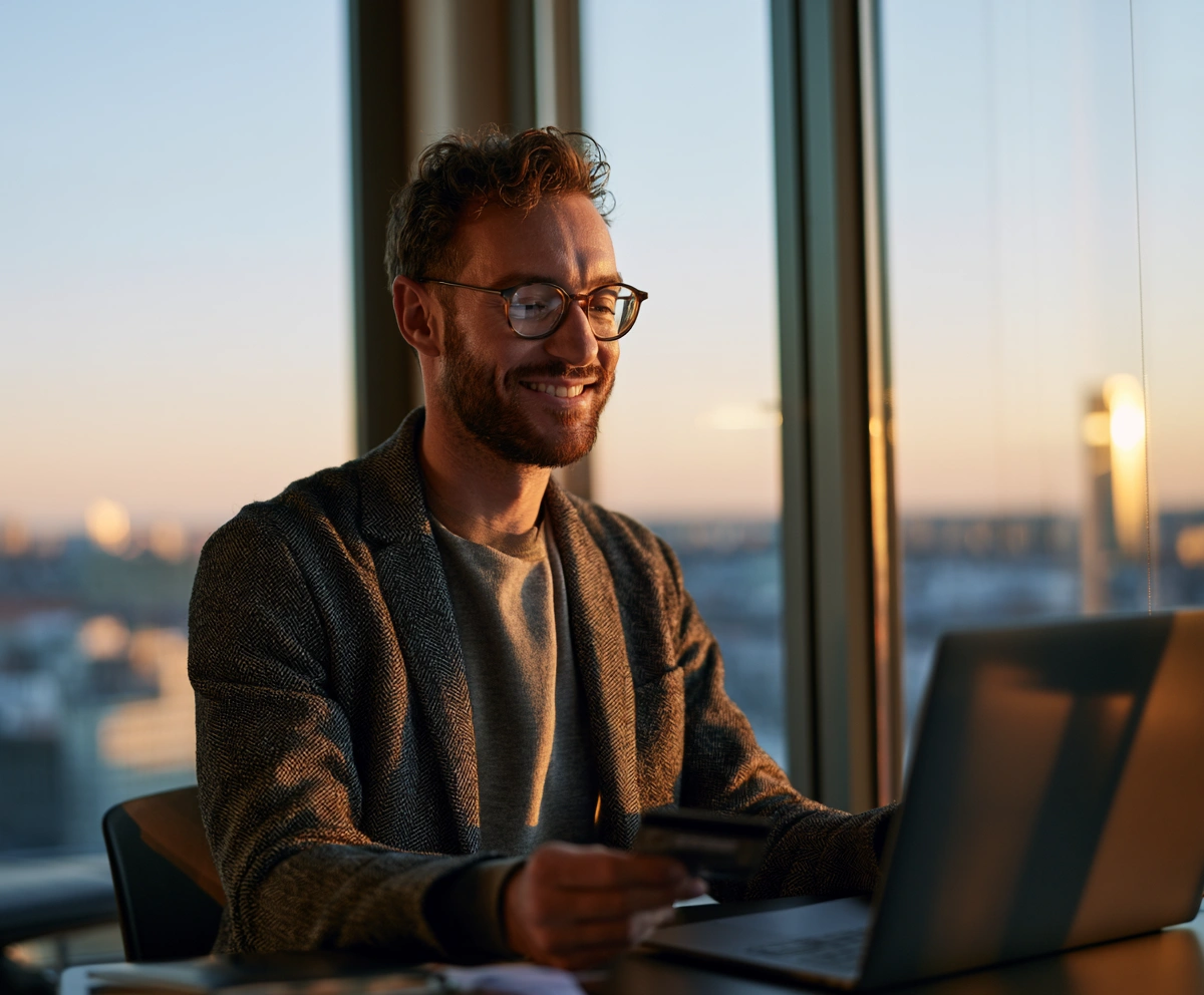 Young professional paying rent and bills online with a laptop